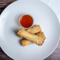 Crispy Spring Rolls · Flash-fried rolls stuffed with cabbage, carrots, and shiitake. Served with sweet and sour sa...