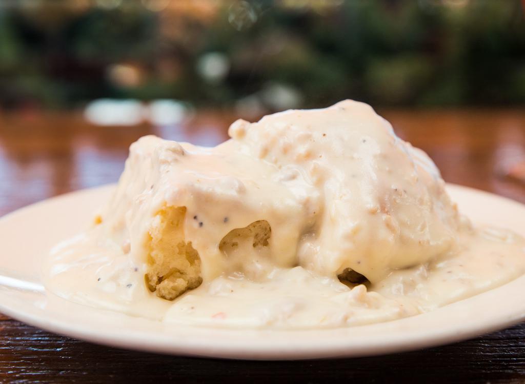 Our Famous Biscuits & Gravy · Fluffy homemade buttermilk biscuit topped with our famous country sausage gravy!.
