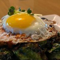 Roasted Brussels Sprouts · Pork belly, balsamic glaze, romesco sauce and fried egg.