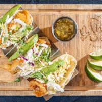 Crispy Fish Tacos · Ale battered cod, avocado, cabbage slaw, and queso fresco.