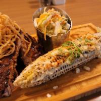 Bbq Ribs · Smoked & grilled ribs, Mexican street corn, fried onion strings, house slaw.