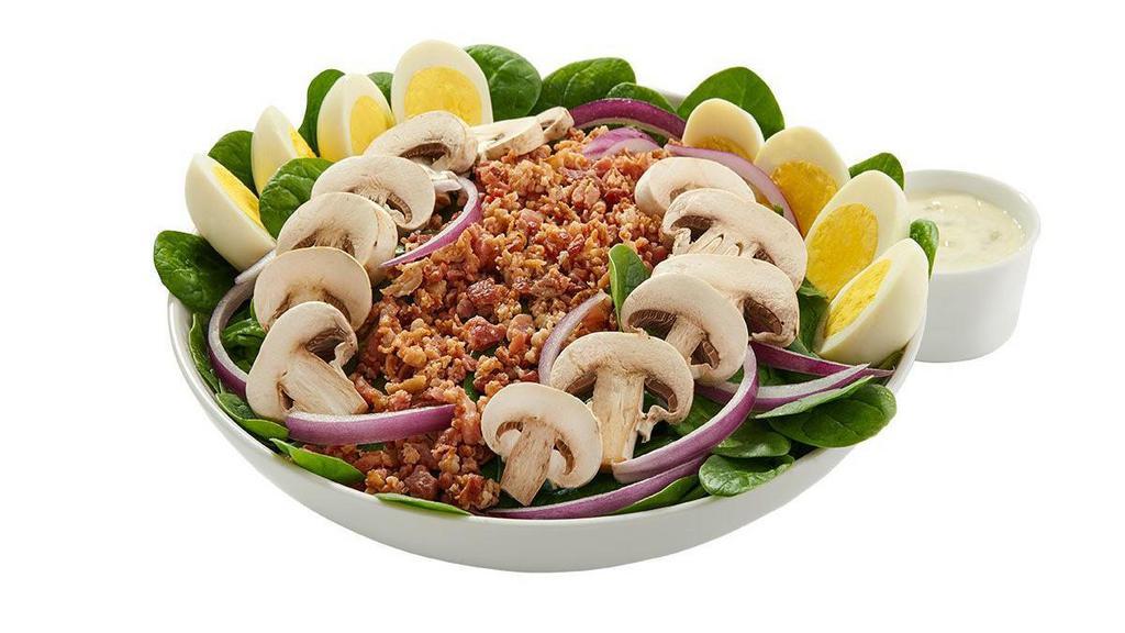 Spinach Salad · Tender baby spinach greens topped with crumbled bacon, red onion, fresh mushrooms and hard-boiled eggs. Served with your choice of dressing.