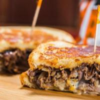 Southwestern Tri Tip Melt · Marinated tri-tip served on Parmesan-crusted sourdough with a blend of melted Cheddar and Pe...