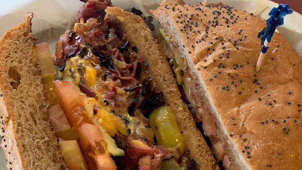 Chicago Pastrami · Tender juicy pastrami stacked high on our poppy seed bun with tomato, pickle, pepperoncinis, grilled onions, Pepper Jack, and Cheddar cheeses, mustard.
