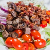 Tri-Tip Steak Cobb Salad · Leaf lettuce, red onion, red bell pepper, tomato, Bleu cheese, bacon and chopped tri-tip cuts.