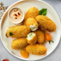 Holy Jalapeño Poppers · (Vegetarian) Fresh jalapenos coated in cream cheese and fried until golden brown.