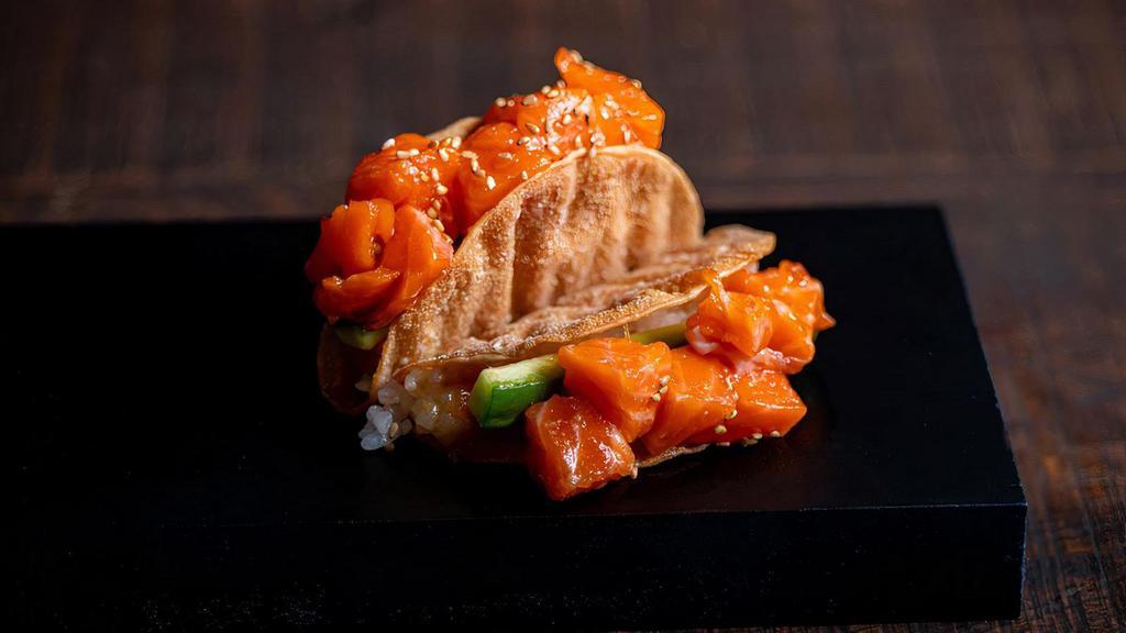 Salmon Taco · Salmon, Miso vinegar, cucumber, sushi rice and  sesame seeds in a Gyoza shell.  Order come with two tacos.