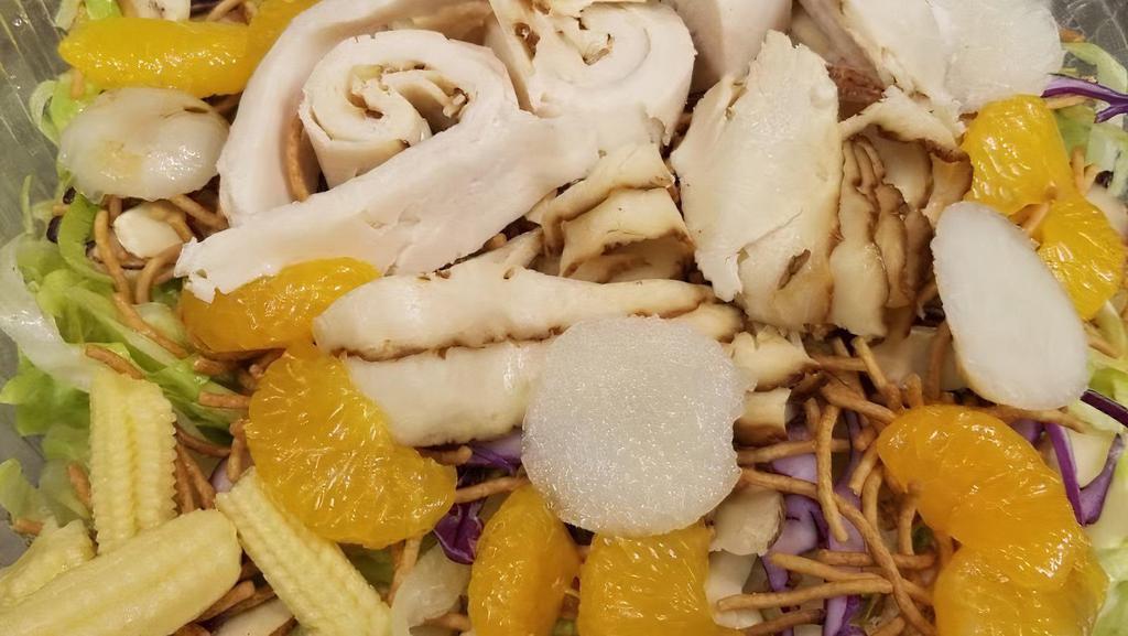 Chinese Chicken Salad · Mixed Greens, Chicken, Mandarin Oranges, Crunchy Chow Mein Noodles, Water Chestnuts, Sliced Almonds with Asian Sesame Dressing.