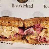Classic Reuben · Corned Beef, Melted Swiss Cheese, Grilled Sauerkraut, and Creamy Thousand Island Dressing on...
