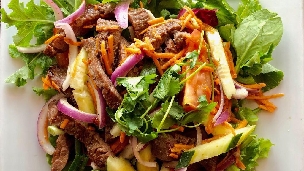 Beef Salad · Marinated grilled beef sliced placed atop mixed greens, cucumber, tomato, onions and finished with our traditional spicy lime dressing.