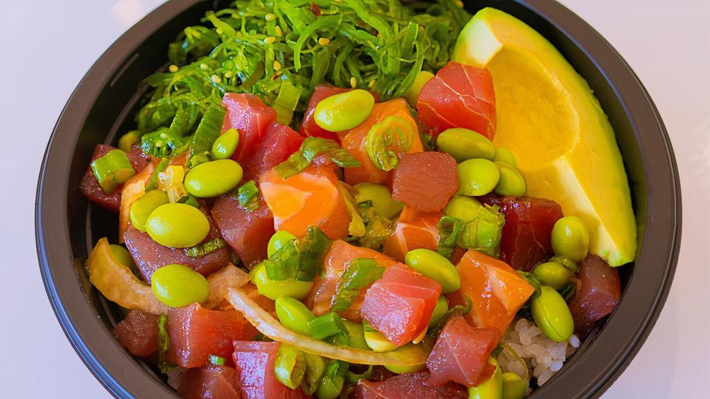 Poke Fix Bowl · Ahi Tuna (2 scoops), Salmon, edamame beans, wakame, avocado, green onions, yellow onions, dried seaweed, with sesame shoyu + citrus ponzu sauces.