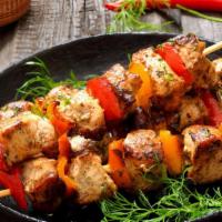 Chicken Shish Kabob · Tender chunks of marinated chicken filet in between a medley of onions, green peppers, and t...