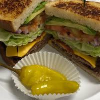 Garden Deli Burger · 2 beef patties with 2 slices of american cheese, avocado, bacon, grilled onions, tomatoes, l...