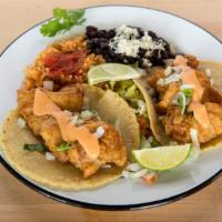Tilapia · Two petito tacos filled with fresh tilapia beer battered on a corn tortilla. Served with oni...