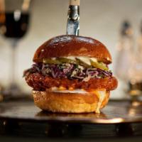 Golden Spur Chicken Burger · country fried chicken breast tossed in buffalo sauce, slaw, lemon-herb mayo, pickles, brioch...