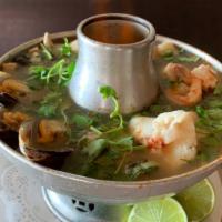 Spicy Seafood Soup · Fish, squid, shrimp, scallops and mussels in spicy lemongrass soup with mushrooms. Spicy.