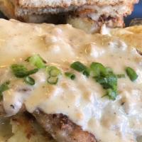 Chicken Fried Steak And Eggs · With 2 eggs, griddled potatoes & toast topped with peppery pork gravy.