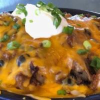 Dirty Potatoes · Topped with our chili + cheese + sour cream + green onions.