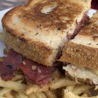 Reuben · Tender corned beef with sauerkraut, 1000 island & Swiss on rye.