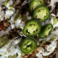 Carne Asada Nachos · Chips with carne asada with guacamole, sour cream,cheese and pico de gallo