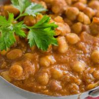 Chana Masala · Garbanzo beans cooked in Himalayan herbs and spices with onion and tomato sauce.