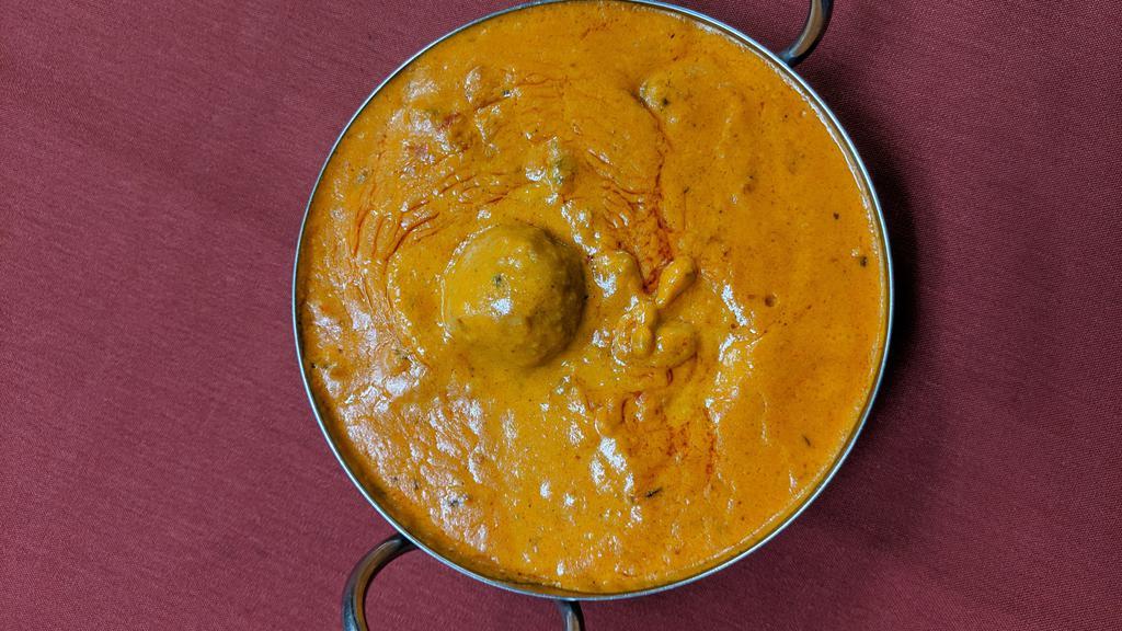 Malai Kofta · Mashed homemade cheese, potatoes, cashew nuts, and spices combine together to make balls of malai kofta and then cooked with specially prepared tomatoes and onion creamy sauce with Himalayan herbs and spices.