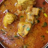 Chicken Curry · Boneless chicken cooked in onion and tomato gravy with himalayan herbs and spices.