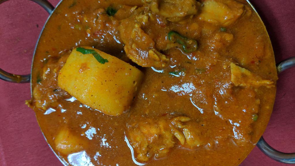 Chicken Vindaloo · Boneless chicken, potato, onion and tomato gravy cooked in Himalayan herbs and spices, vinegar and vindaloo sauce.