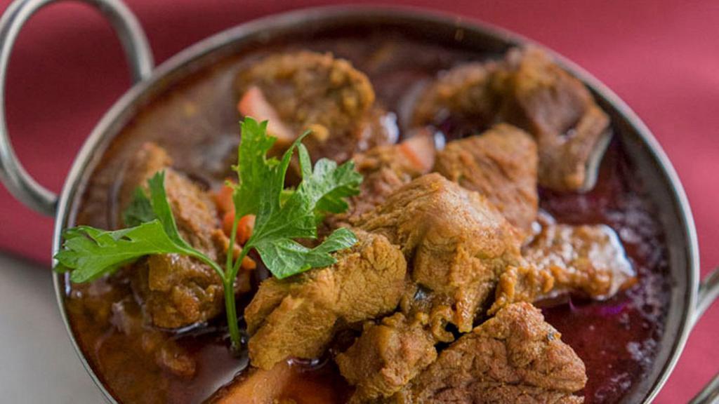 Lamb Curry · Boneless lamb cooked in onion and tomato sauce with Himalayan herbs and spices.