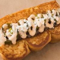Old Town · Smoked bacon dog, Carmelized onions, chipotle aioli, pickled jalapenos, cotija cheese.