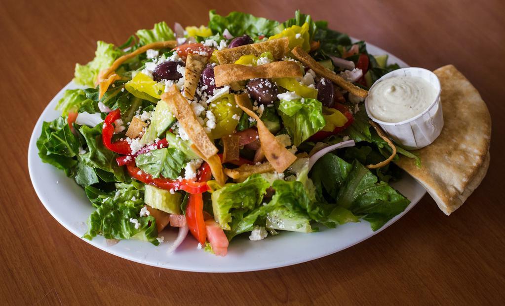 Greek Salad · Romaine lettuce, tomatoes, red onions, cucumbers, red bell peppers, Feta cheese, kalamata olives and pepperoncini, tossed in our Greek vinaigrette dressing.