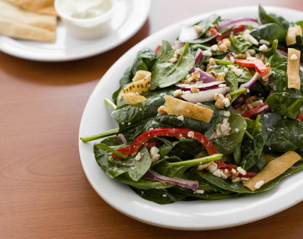 Spinach Salad · Spinach, red onions, red bell peppers, Feta cheese, candied almonds & pita chips, tossed in our citrus vinaigrette dressing.
