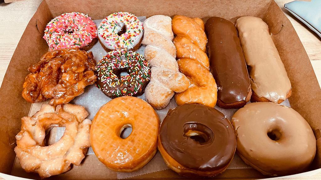 A Dozen Mixed Donuts · Assortment of 12 donuts.
Normally Includes: 
4 long raised donuts ( chocolate or maple bars & twists).
4 cake donuts (white or chocolate cakes with sprinkles or without sprinkles).
4 mixed donuts (glazes, filled donuts, old fashion, buttermilk bars, or french cruller).

For specific donut selection, please use the 
