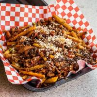 Wild Fries · Carne asada, carene adobada, bacon, guacamole, cheese & sour cream