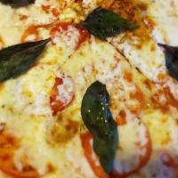 Margherita Pizza · Roma tomato, basil leaves, extra virgin olive oil base and mozzarella cheese.