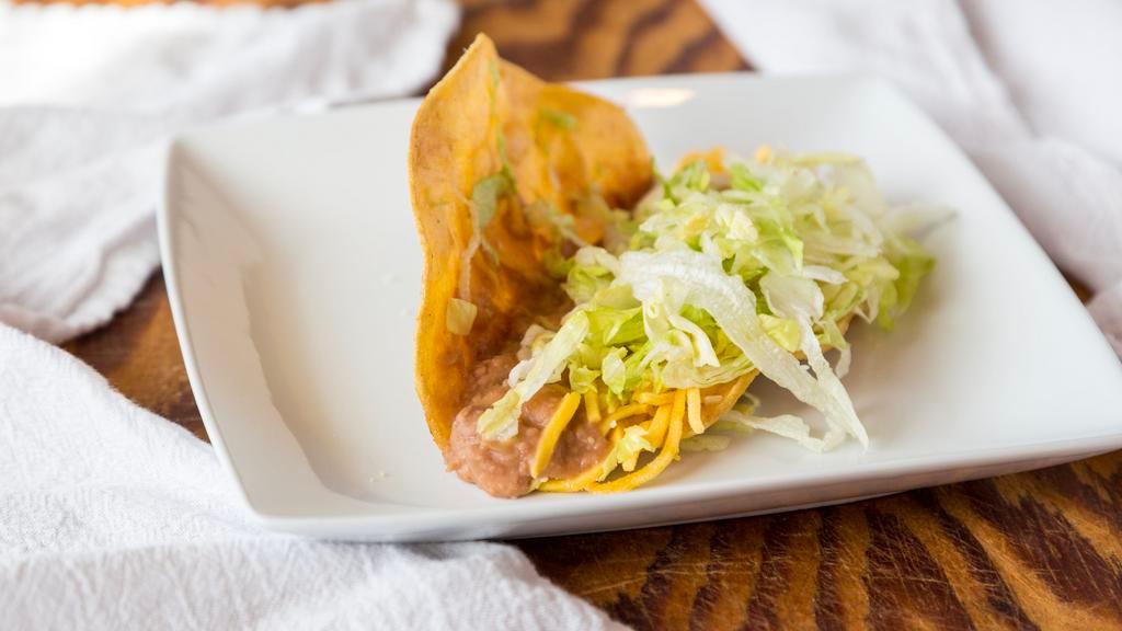 Bean Taco · Chef-griddled stone ground corn tortilla, cheese, lettuce, Parmesans dusted.