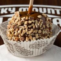 Almond Bear Caramel Apple · A granny smith apple covered in fresh caramel then rolled in almonds, drizzled in milk choco...