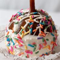 Sprinkles Apple · Delicious Carmel apple dipped in white confection, covered in candy sprinkles