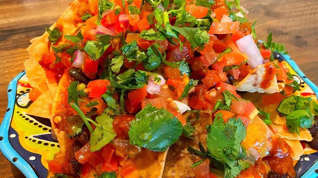 Not Yo' Nachos-Carnitas · Half order. Tortilla chips, our nut free queso (cheese), pico de gallo, black beans, and our Canitas plant protein. Suggest adding guacamole.