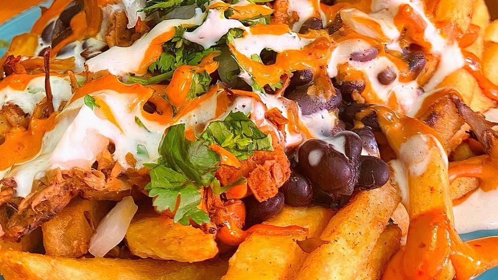 Loaded Fries · Crispy fries covered in our queso (dairy & nut free), beans, plant based meat of your choice, salsa, chipotle crema, onion, crema and cilantro.