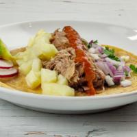 Carnitas Taco · Pork carnitas, pineapple, fermented sauce, red onion, and cilantro.
