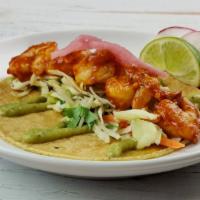 Spicy Shrimp Taco · Spicy shrimp in diablo sauce, verde slaw, pickled red onions, and avocado crema.