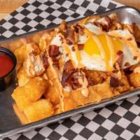 Loaded Breakfast Tots · Tater tots topped with a fried egg, cheddar cheese, chicken tenders, bacon, and sriracha aio...