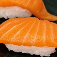 Salmon Nigiri · Two pieces raw sliced salmon over sushi rice.