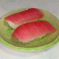 Tuna Nigiri · Two pieces raw sliced tuna over sushi rice.