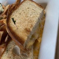 Truffled Grilled Cheese · Basil-garlic butter, gruyère, cheddar, Swiss, truffle oil, country white bread.