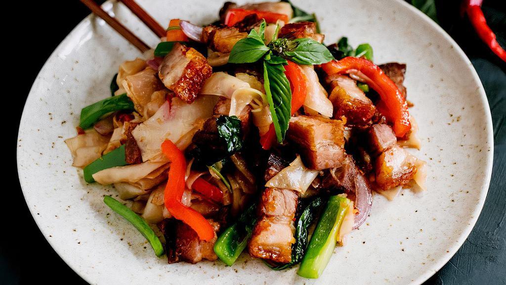 Drunken Noodles · An experience for the senses! Wide rice noodles in a variety of tomatoes, bell peppers, onions, garlic, Thai basil, and chili in a savory sauce, creating an intoxicating experience.