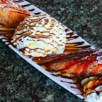 Xiangjiao · An egg roll filled with banana cheesecake, rolled in cinnamon and topped with powdered sugar...