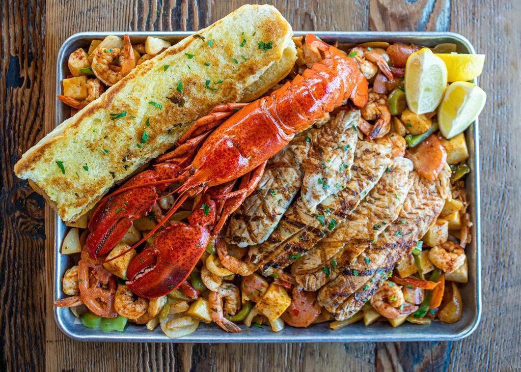 Super Tray · Shrimp, whole Maine lobster, white fish fillet, SPFM veggie mix seared “a la plancha” style. Served with Garlic Bread