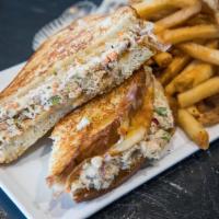 Tuna Melt · Our Signature tuna salad melted cheddar cheese served on grilled sourdough bread.